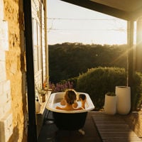 The outdoor claw bath that sits on the deck of Ode to Orchard as the sun streams in